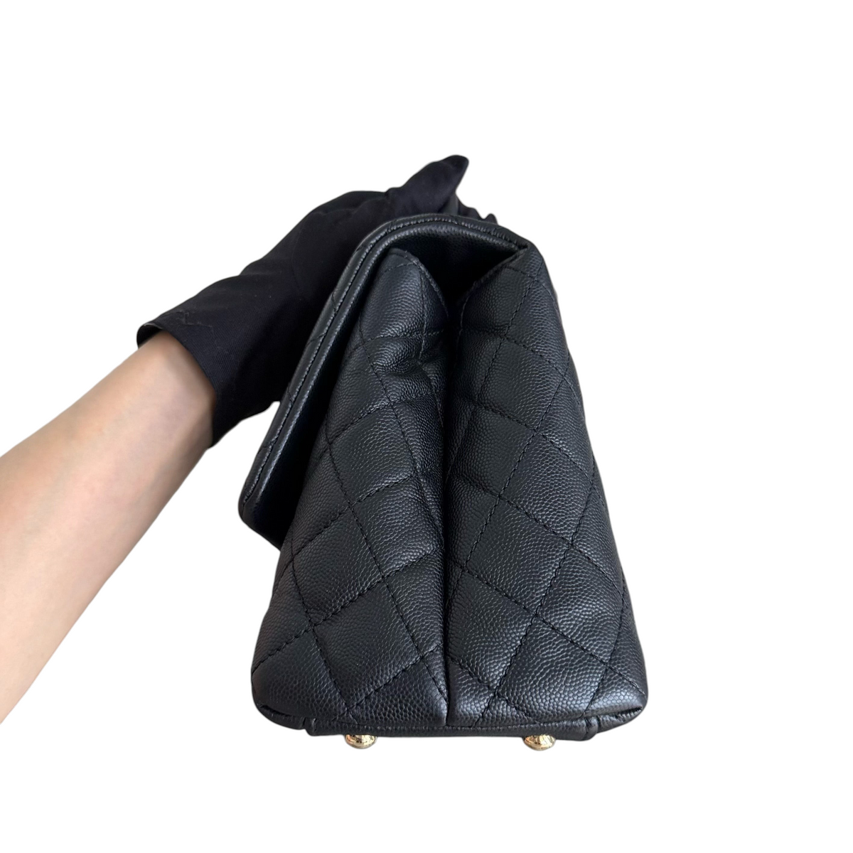 Luxury Evermore Chanel Coco Handle medium bag in black quilted caviar leather with gold hardware side view