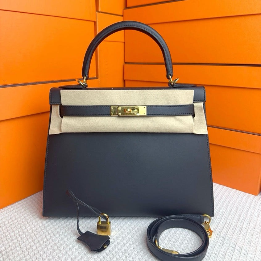 Hermes Kelly 28, black and gold Tadelakt leather, exterior stitching A engraving, SYC2177