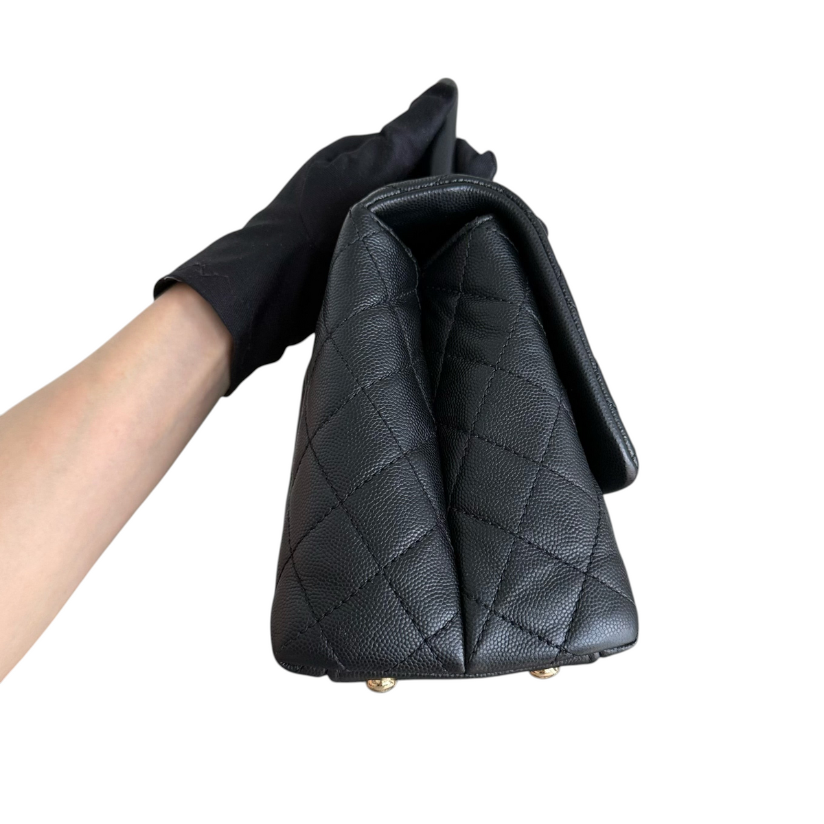 Luxury Evermore Chanel Coco Handle medium bag in black quilted caviar leather with gold hardware side view