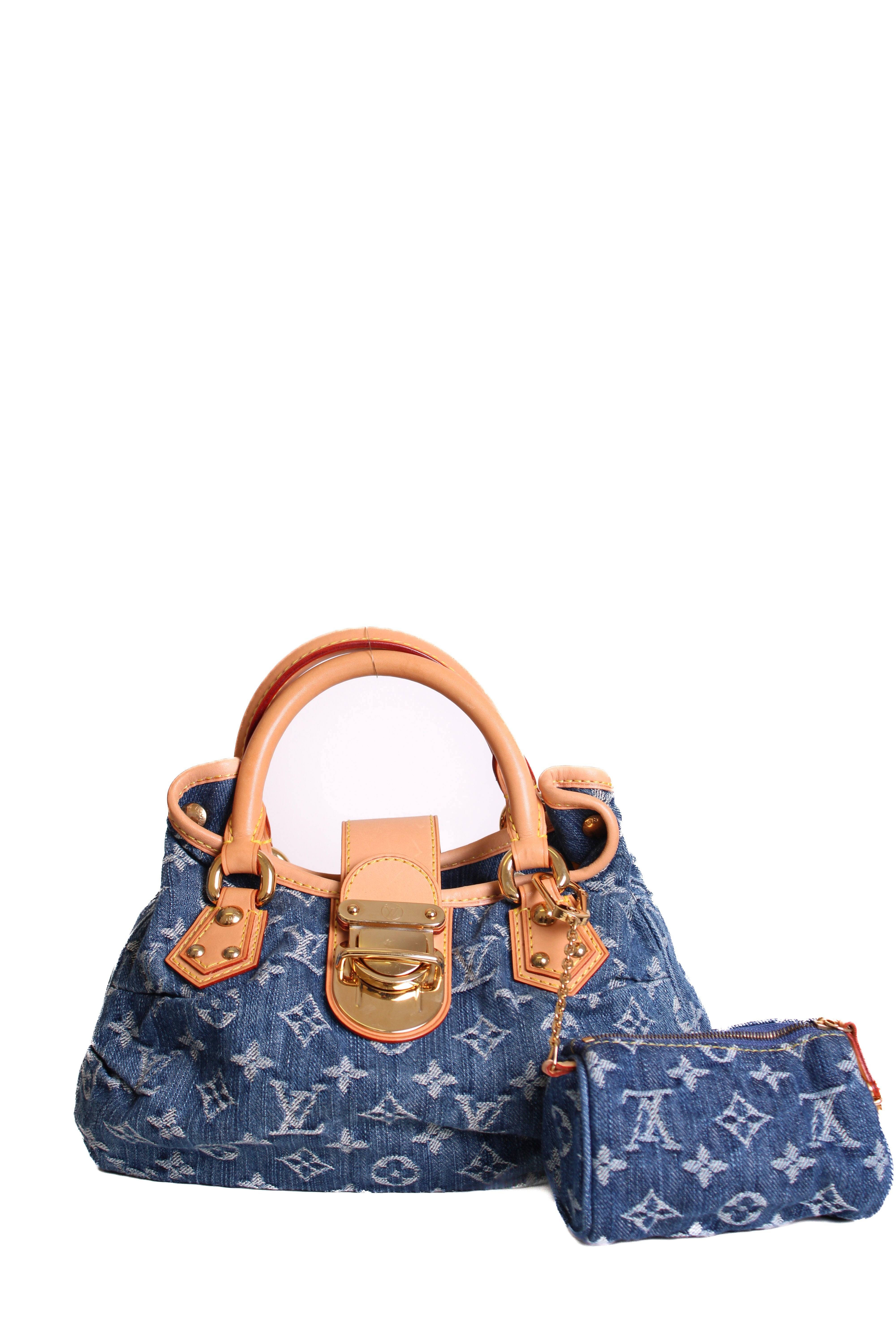 Denim handbag with brown leather handles and accents on a white background