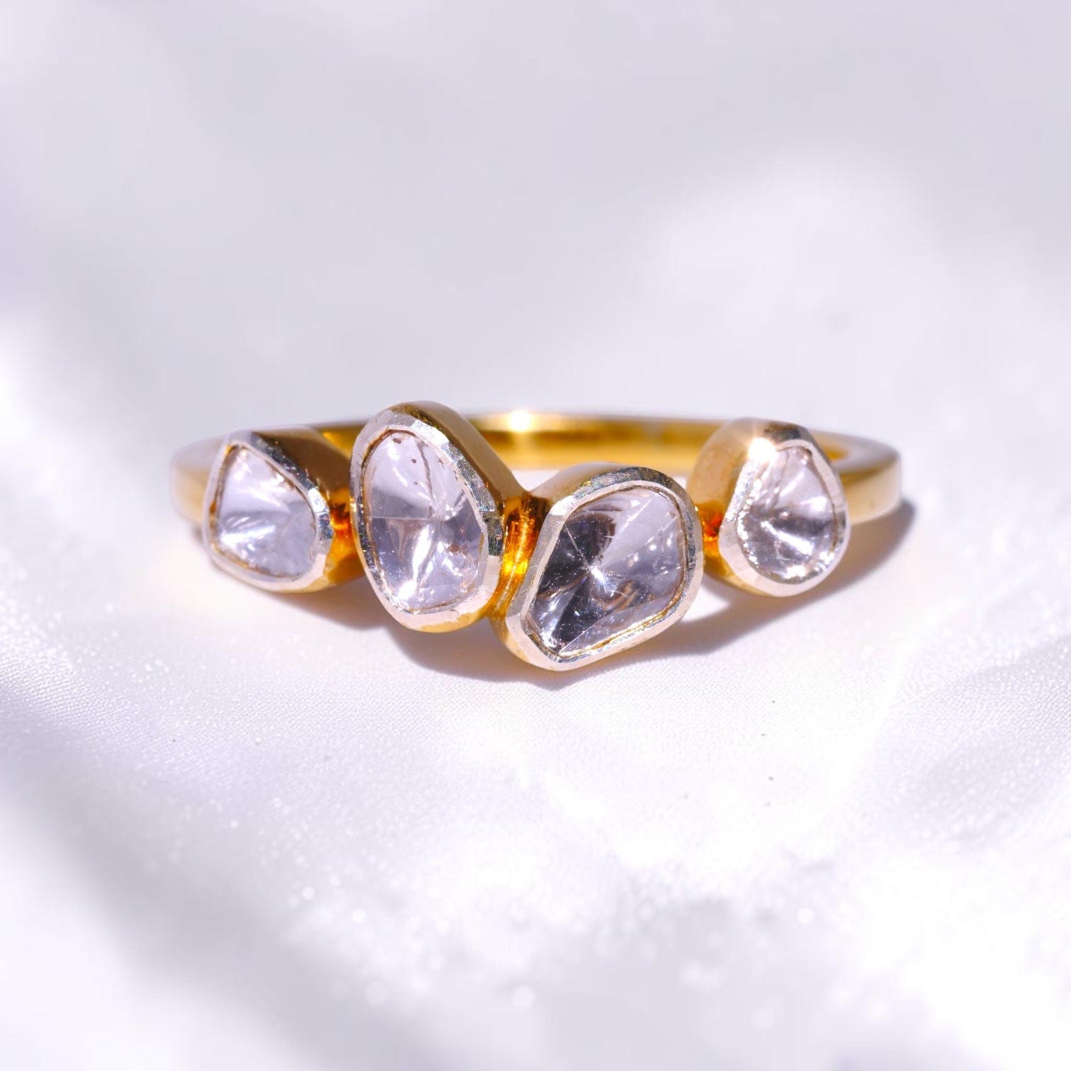 Gold ring set with four uncut polki diamonds