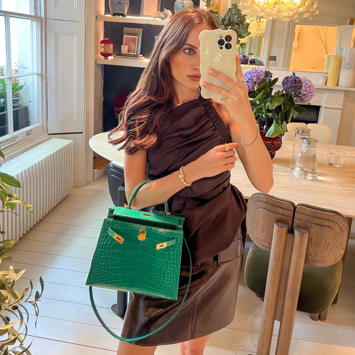 model holds green croc hermes kelly 25