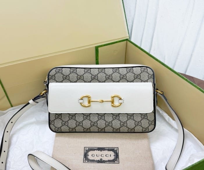 Gucci Gucci white monogrammed 1955 horsebit camera bag, priced at 22.5. 21677677