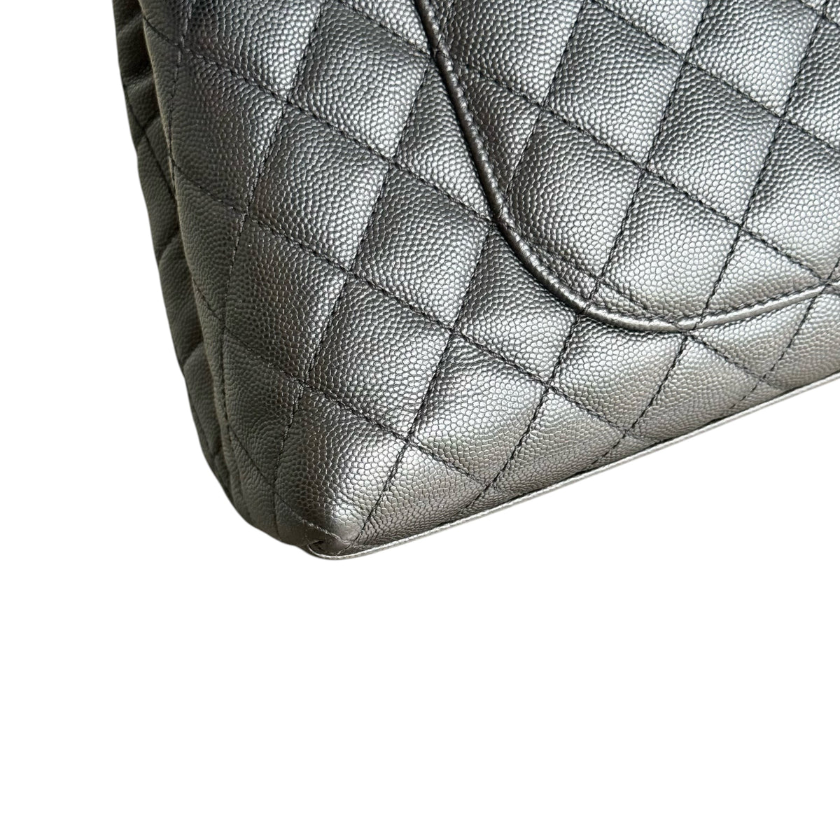 Luxury Evermore Chanel Coco Handle bag in black quilted caviar leather with a close-up of the textured finish