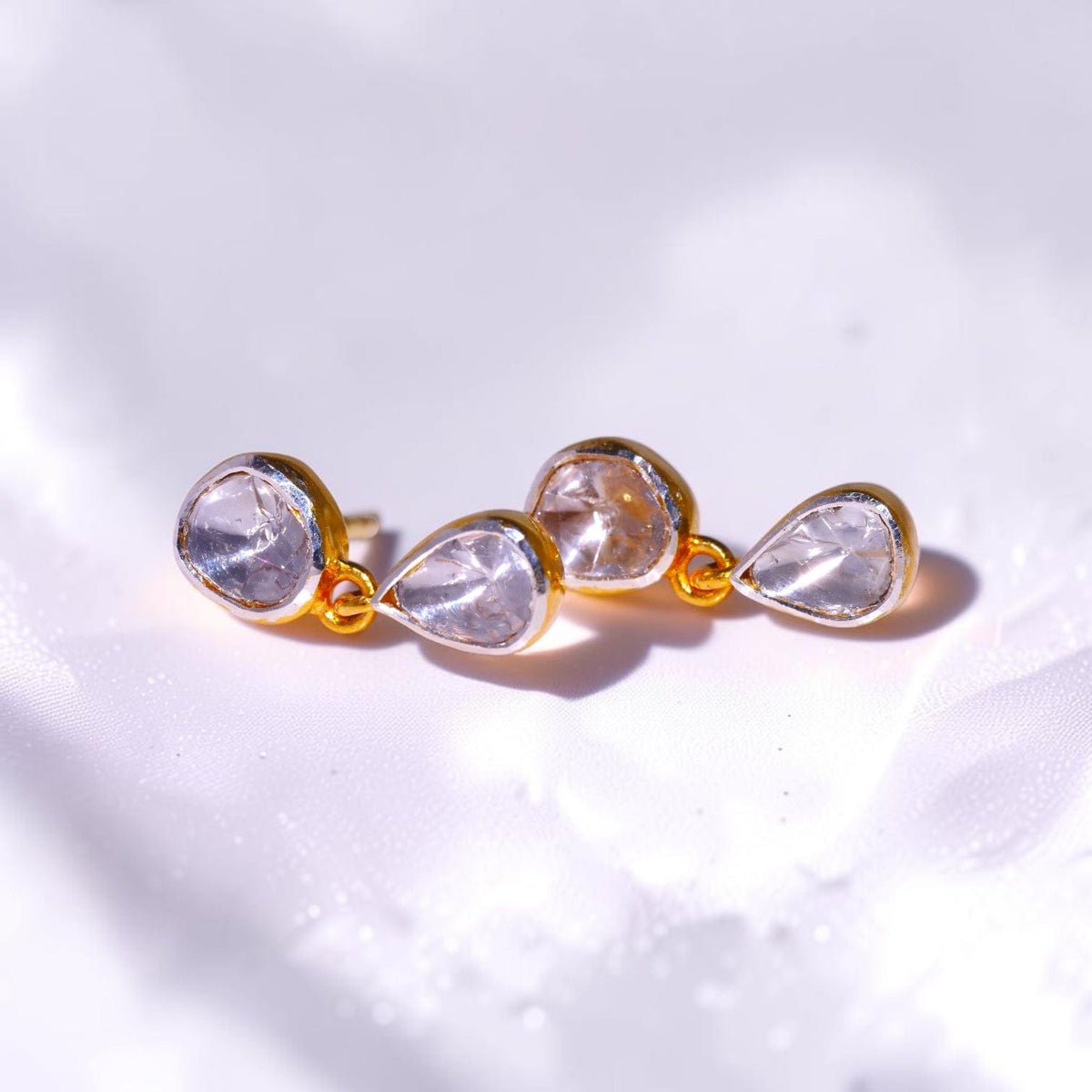 Pair of gold drop earrings set with uncut polki diamonds