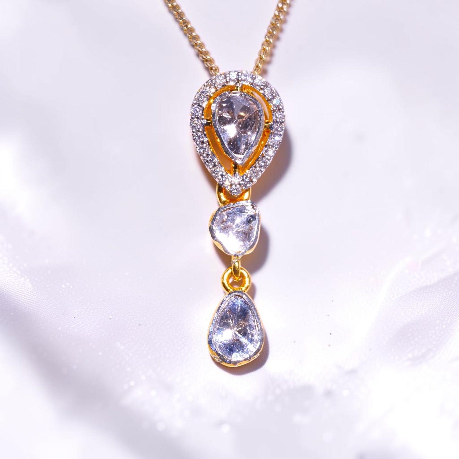 Gold pendant set with three uncut polki diamond drops