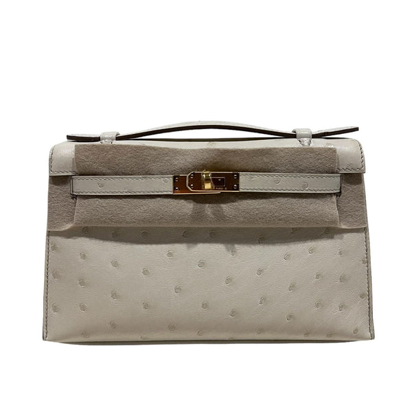 A GRIS ASPHALTE OSTRICH KELLY POCHETTE WITH GOLD HARDWARE