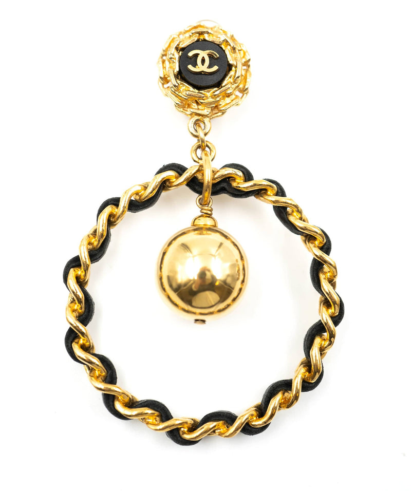 Chanel black and gold leather hoops with CC logo and ball
