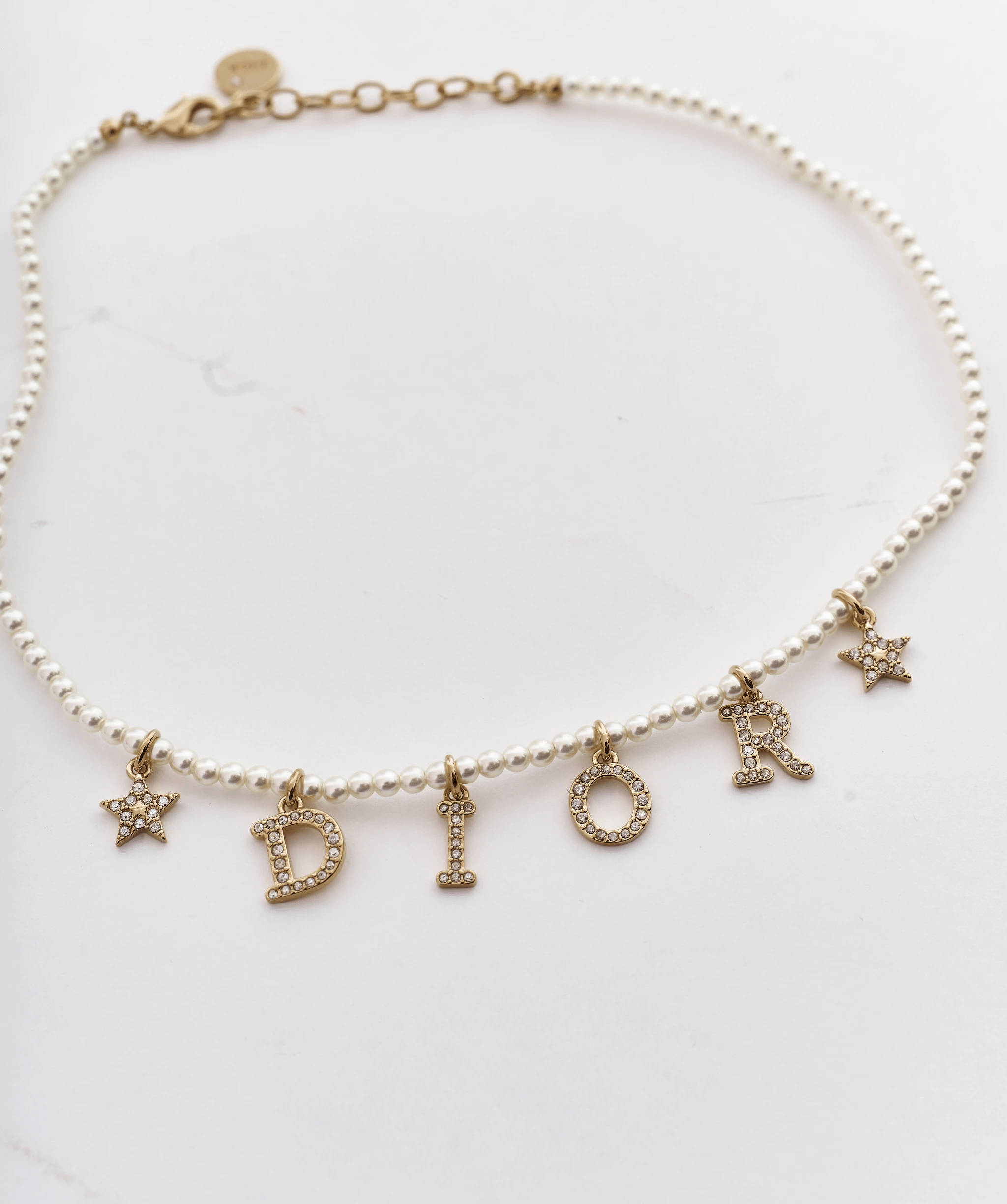 Christian Dior pearl necklace with gold ‘DIOR’ and stars – Luxury