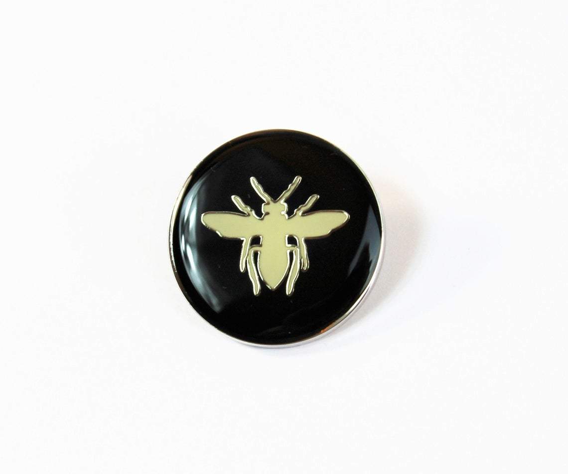 Christian Dior Dior Bee Pin with black background and white bee