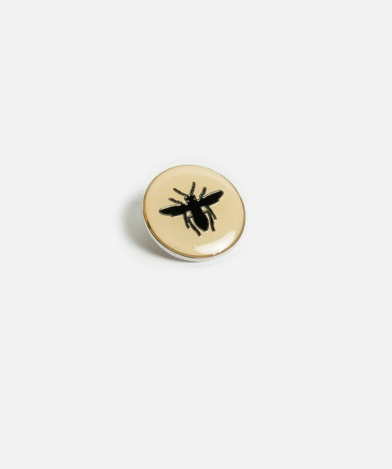 Christian Dior Dior Bee Pin with cream background and black bee